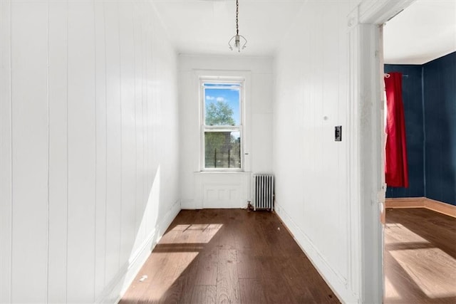 entryway with baseboards, radiator, and wood finished floors