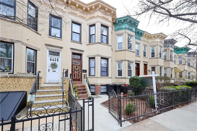 436 76th St, Brooklyn, NY 11209 - view of front facade with entry steps, a fenced front yard, and a residential view
