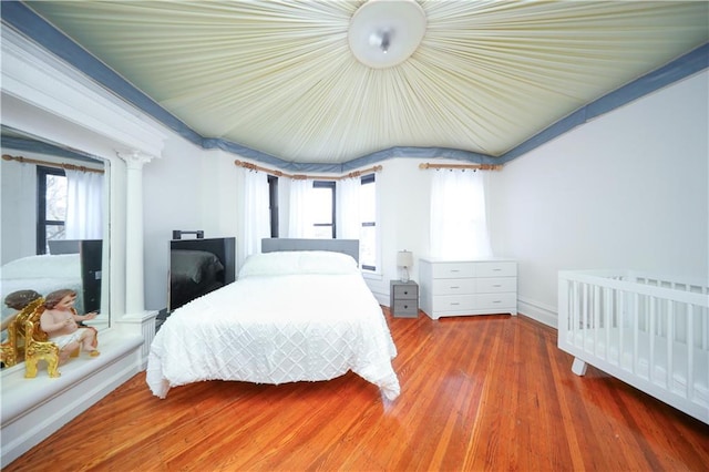 436 76th St, Brooklyn, NY 11209 - bedroom featuring wood finished floors, ornate columns, and baseboards
