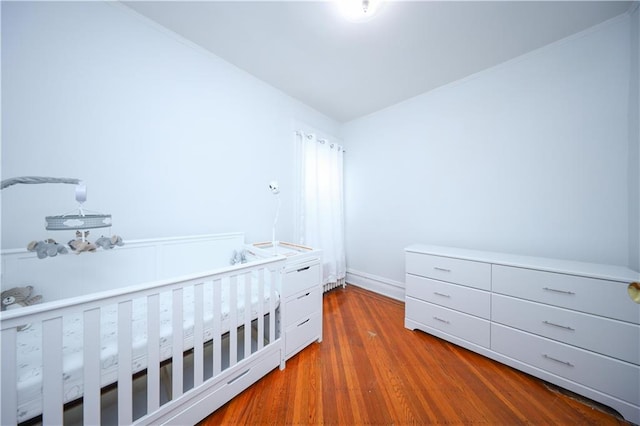 436 76th St, Brooklyn, NY 11209 - unfurnished bedroom featuring wood finished floors and baseboards
