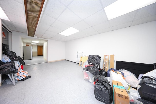 436 76th St, Brooklyn, NY 11209 - below grade area with freestanding refrigerator, tile patterned floors, and a paneled ceiling