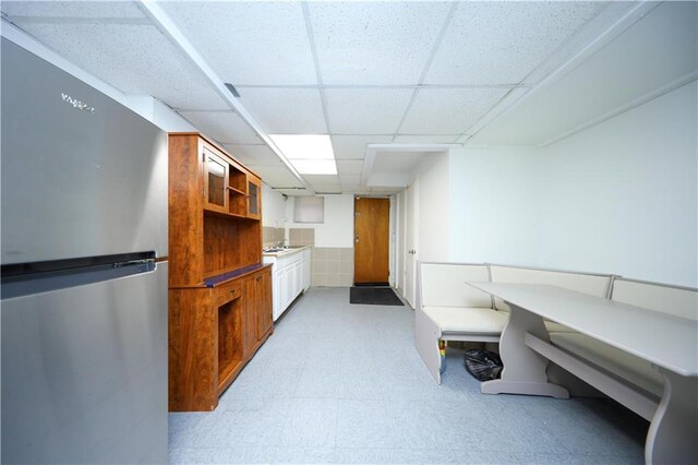 436 76th St, Brooklyn, NY 11209 - bar featuring freestanding refrigerator, light flooring, and a drop ceiling