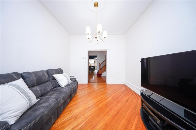 436 76th St, Brooklyn, NY 11209 - living room featuring a chandelier, light wood-type flooring, and baseboards