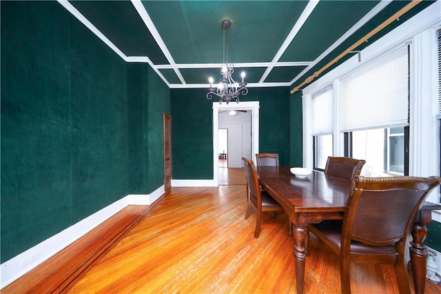 436 76th St, Brooklyn, NY 11209 - dining space featuring a chandelier, light wood-type flooring, coffered ceiling, and baseboards