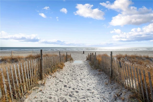 view of street with view of water and beach