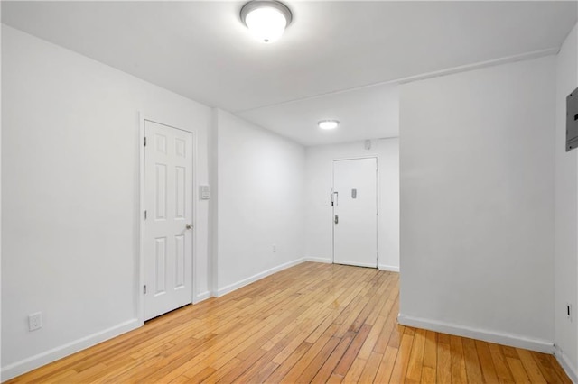 empty room with light wood-style floors and baseboards