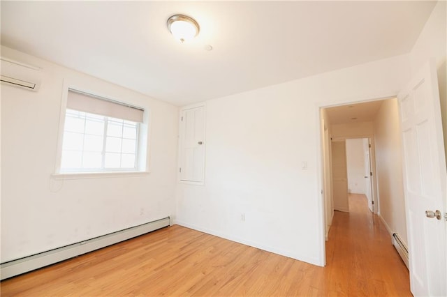 69 Bay 20th St Unit 3A, Brooklyn, NY 11214 - spare room featuring baseboard heating, light wood finished floors, a wall mounted AC, and baseboards