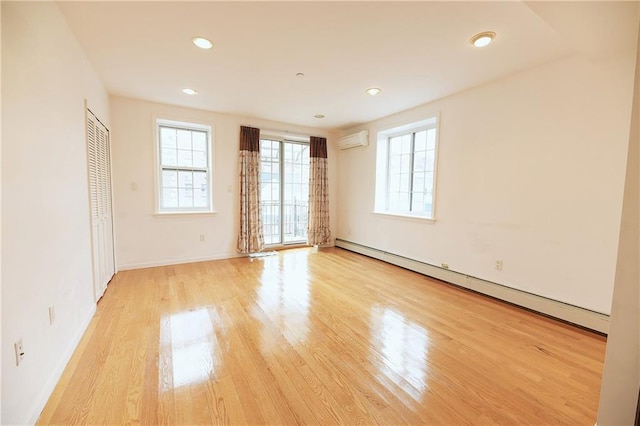 69 Bay 20th St Unit 3A, Brooklyn, NY 11214 - unfurnished room featuring a baseboard radiator, light wood-style flooring, a wall unit AC, recessed lighting, and baseboards