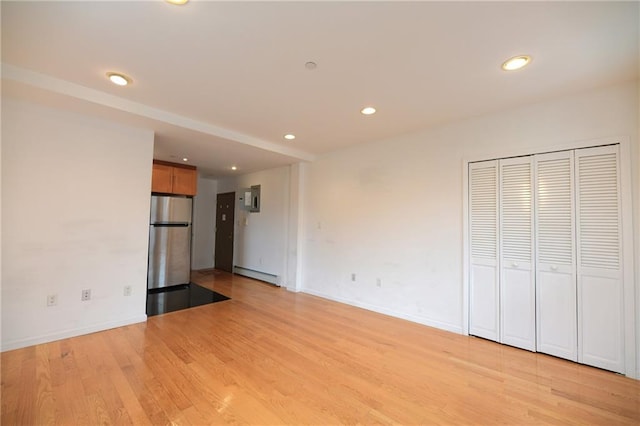 69 Bay 20th St Unit 3A, Brooklyn, NY 11214 - unfurnished living room featuring a baseboard radiator, recessed lighting, light wood finished floors, and baseboards
