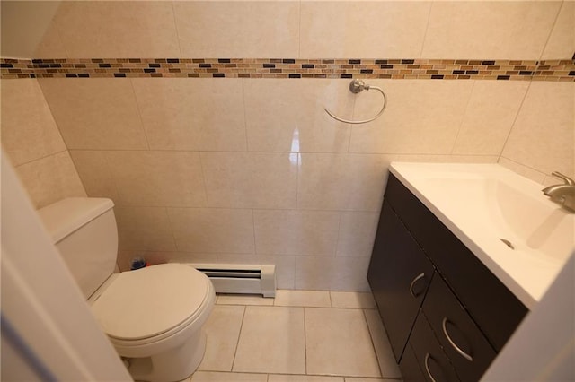 69 Bay 20th St Unit 3A, Brooklyn, NY 11214 - half bathroom featuring a baseboard radiator, tile walls, vanity, toilet, and tile patterned floors