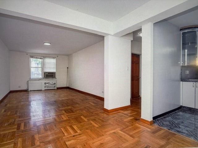 2727 Ocean Pkwy Unit A14, Brooklyn, NY 11235 - unfurnished living room featuring baseboards and cooling unit