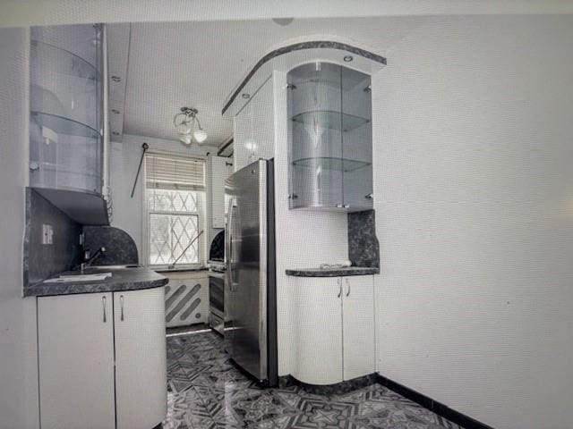 2727 Ocean Pkwy Unit A14, Brooklyn, NY 11235 - kitchen featuring freestanding refrigerator, dark countertops, white cabinetry, and oven