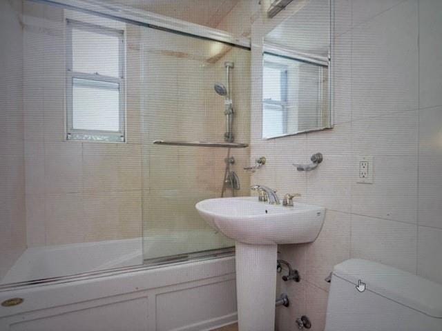 2727 Ocean Pkwy Unit A14, Brooklyn, NY 11235 - full bathroom featuring combined bath / shower with glass door and tile walls