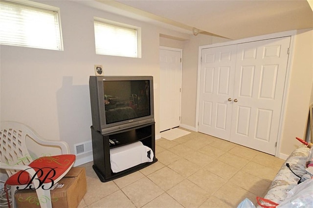 interior space with light tile patterned floors and baseboards