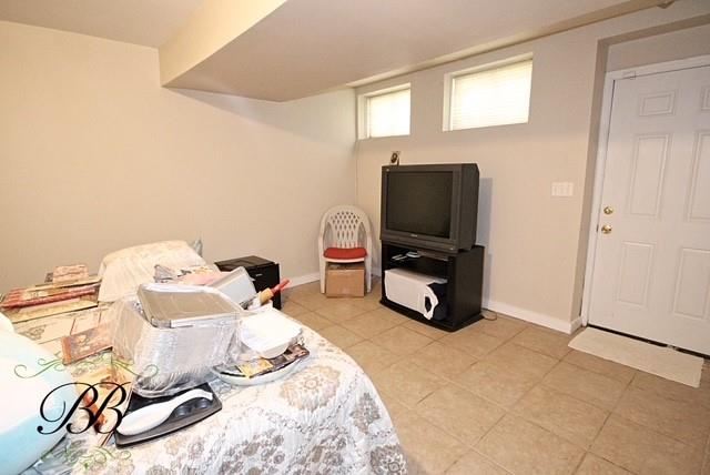interior space featuring light tile patterned floors and baseboards