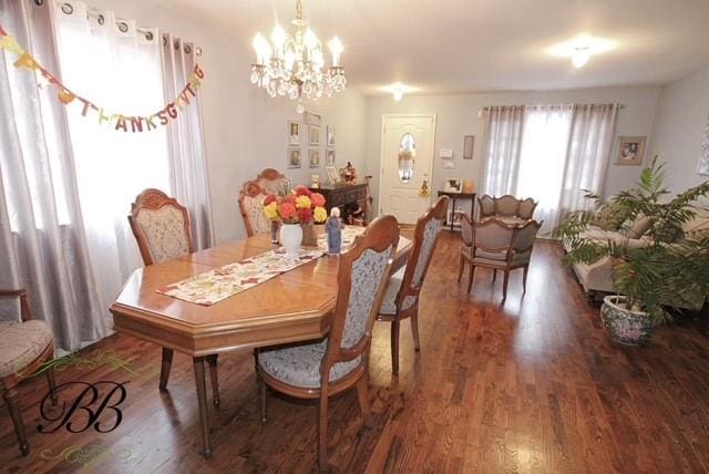 dining space featuring a notable chandelier and wood finished floors
