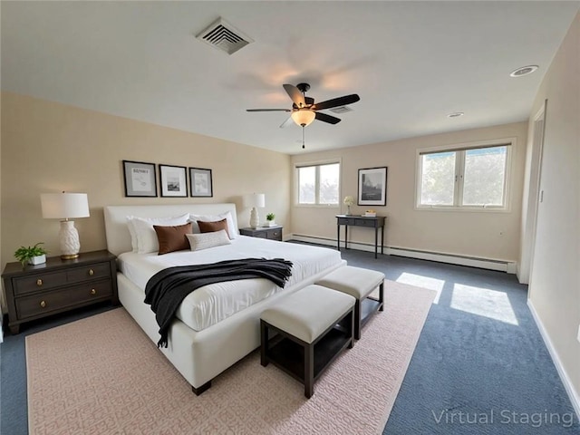 bedroom featuring a baseboard heating unit, carpet flooring, a ceiling fan, and baseboards