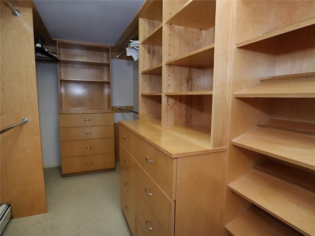 spacious closet with a baseboard radiator
