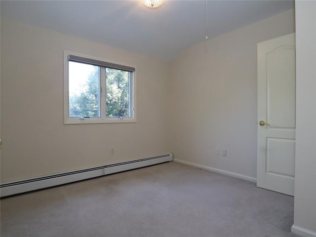 carpeted spare room with a baseboard radiator, baseboards, and vaulted ceiling