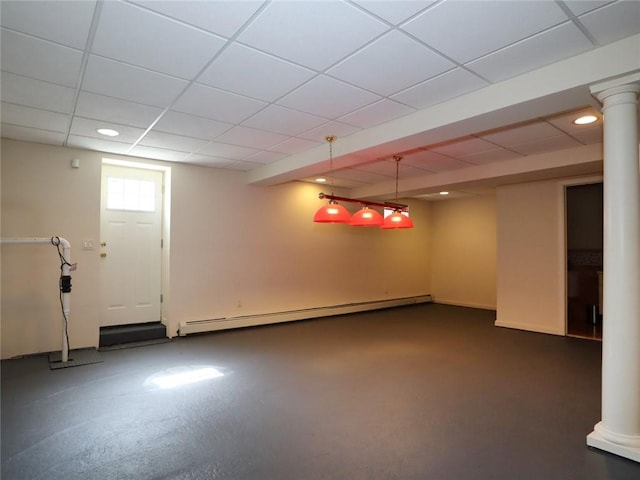 basement featuring a baseboard radiator, a paneled ceiling, and recessed lighting