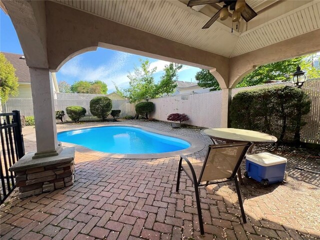 view of pool featuring a ceiling fan, a fenced backyard, and a patio area