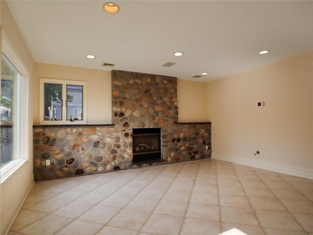 unfurnished living room featuring tile patterned floors, recessed lighting, a fireplace, and baseboards