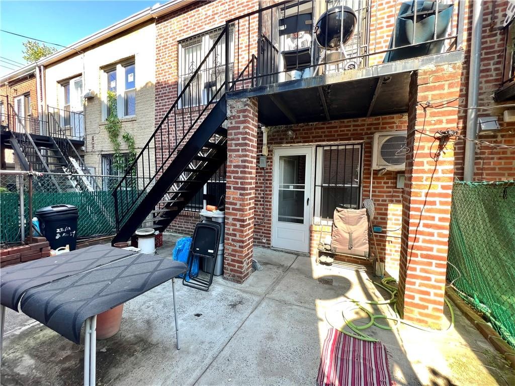 view of patio featuring stairway and fence
