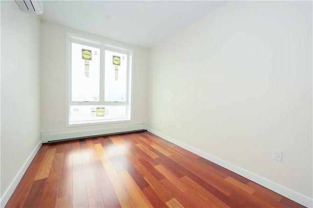 1721 W 6th St Unit 2A, Brooklyn, NY 11223 - spare room featuring a baseboard heating unit, wood finished floors, a wall mounted AC, and baseboards
