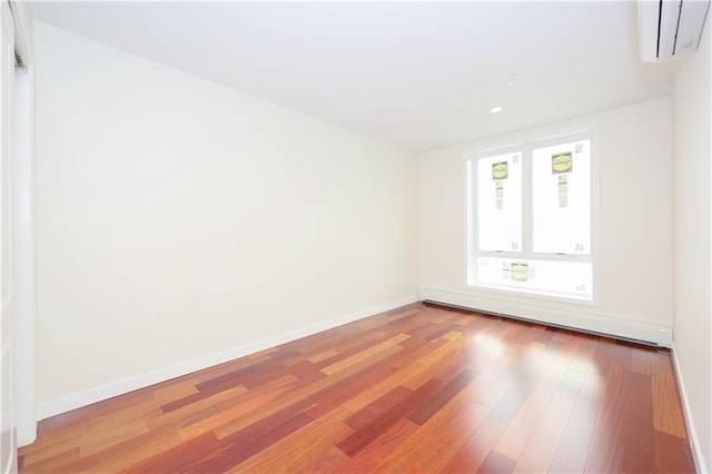 1721 W 6th St Unit 2A, Brooklyn, NY 11223 - empty room with a baseboard heating unit, a wall unit AC, wood finished floors, baseboards, and recessed lighting