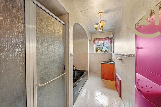 2138 E 26th St, Brooklyn, NY 11229 - full bathroom featuring tile walls, tile patterned flooring, a shower stall, a bath, and a chandelier