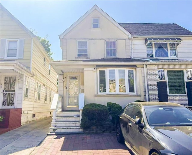 1202 E 46th St, Brooklyn, NY 11234 - view of front facade featuring stucco siding and a shingled roof