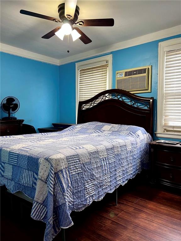 1202 E 46th St, Brooklyn, NY 11234 - bedroom featuring wood finished floors, ceiling fan, a wall unit AC, and ornamental molding