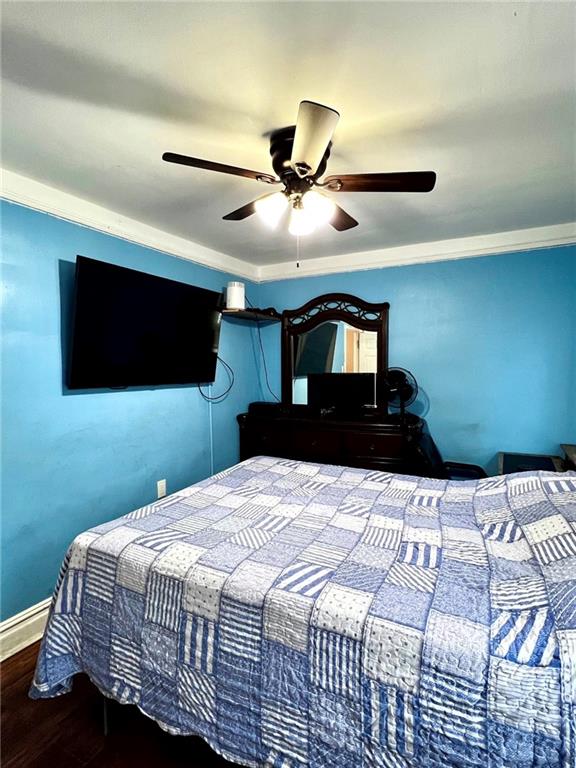 1202 E 46th St, Brooklyn, NY 11234 - bedroom with wood finished floors, a ceiling fan, crown molding, and baseboards