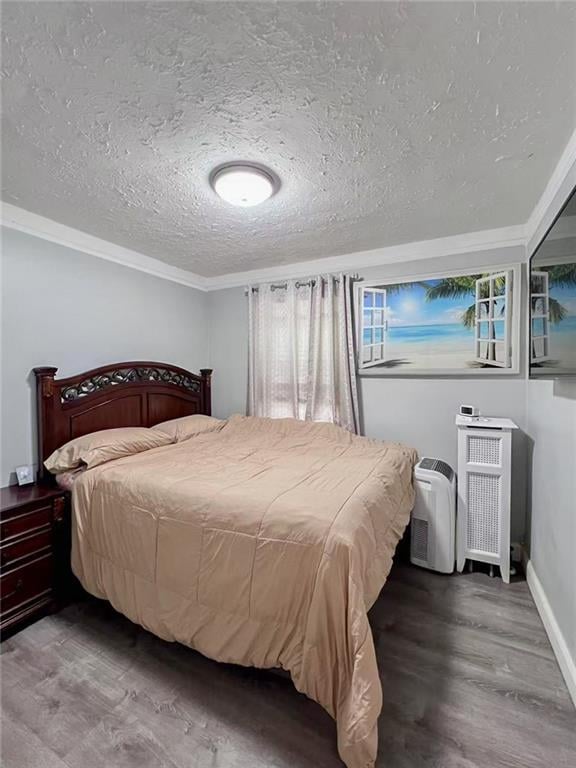 1202 E 46th St, Brooklyn, NY 11234 - bedroom featuring wood finished floors, a textured ceiling, crown molding, and baseboards