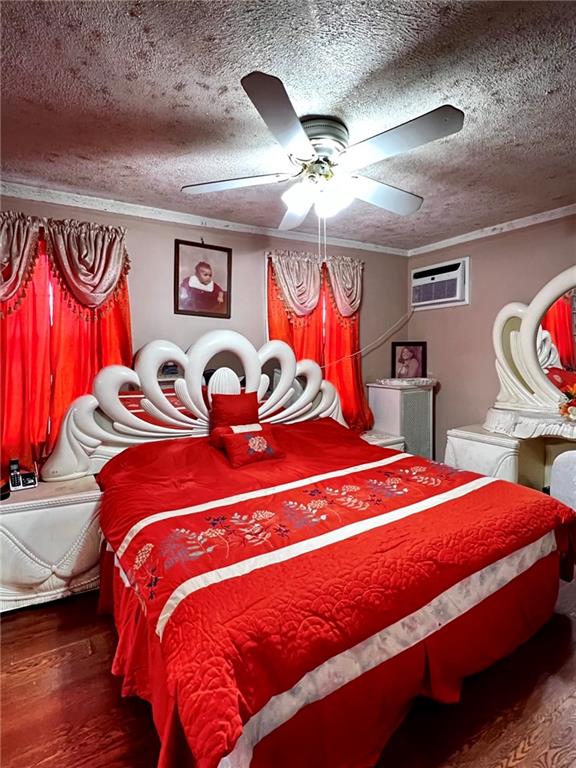 1202 E 46th St, Brooklyn, NY 11234 - bedroom with wood finished floors, crown molding, a textured ceiling, a ceiling fan, and a wall mounted air conditioner