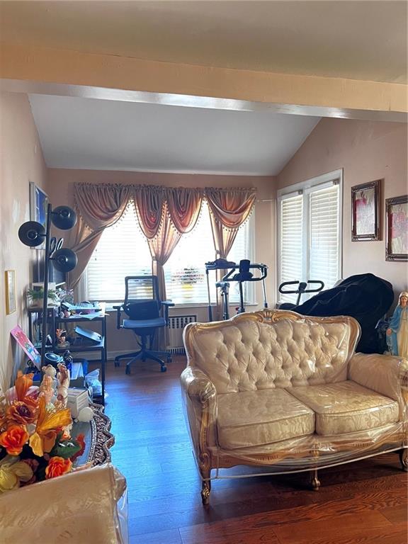 1202 E 46th St, Brooklyn, NY 11234 - living area with vaulted ceiling, wood finished floors, and radiator