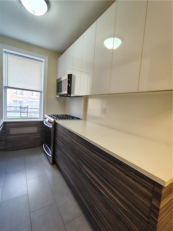 2195 E 22nd St Unit 5C, Brooklyn, NY 11229 - kitchen with stainless steel appliances, modern cabinets, white cabinets, and light countertops