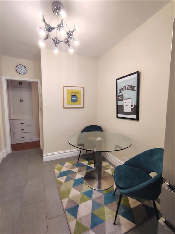 2195 E 22nd St Unit 5C, Brooklyn, NY 11229 - tiled dining area featuring baseboards and a chandelier