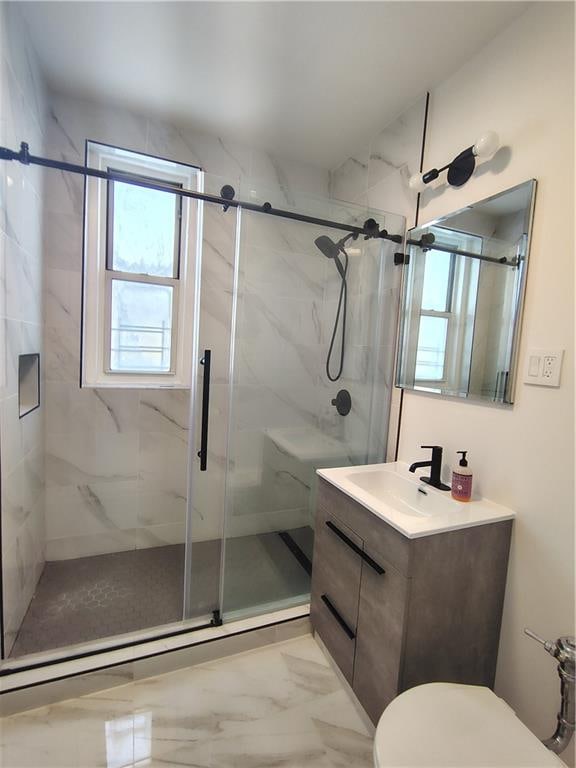 2195 E 22nd St Unit 5C, Brooklyn, NY 11229 - full bath featuring a marble finish shower, vanity, toilet, and marble look tile flooring
