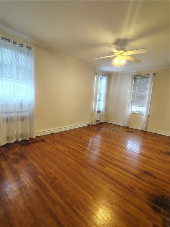 2195 E 22nd St Unit 5C, Brooklyn, NY 11229 - empty room featuring radiator heating unit, hardwood / wood-style flooring, ceiling fan, crown molding, and baseboards