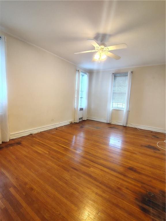 2195 E 22nd St Unit 5C, Brooklyn, NY 11229 - unfurnished room with wood finished floors, a ceiling fan, baseboards, and ornamental molding