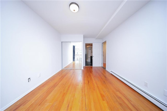 345 92nd St Unit 3B, Brooklyn, NY 11209 - unfurnished room featuring a baseboard heating unit, light wood-style floors, and baseboards