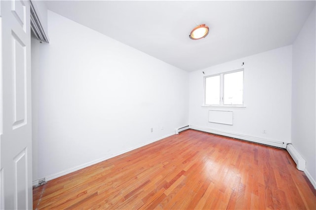 345 92nd St Unit 3B, Brooklyn, NY 11209 - spare room featuring light wood finished floors, a baseboard heating unit, and baseboards