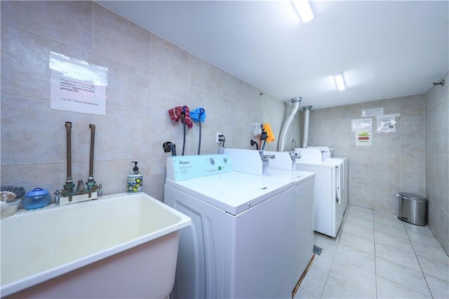 345 92nd St Unit 3B, Brooklyn, NY 11209 - communal laundry room featuring tile walls, separate washer and dryer, and light tile patterned flooring