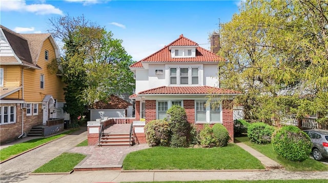 3098 Bedford Ave, Brooklyn, NY 11210 - view of front facade featuring a tiled roof, a chimney, stucco siding, brick siding, and a front lawn