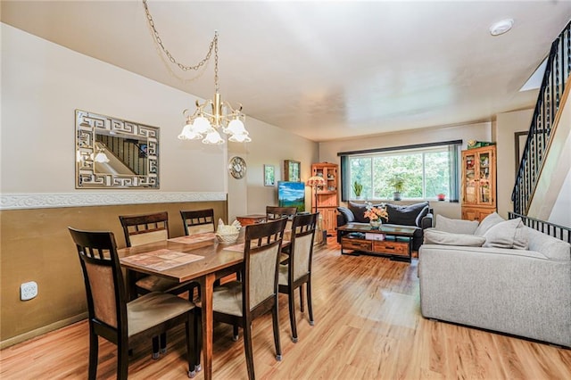 27 Frederick St, Staten Island, NY 10314 - dining room with light wood-type flooring, stairs, and a chandelier