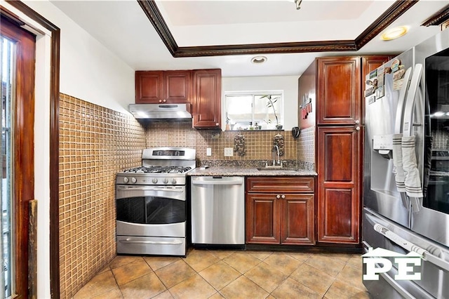 2758 E 26th St, Brooklyn, NY 11235 - kitchen featuring stainless steel appliances, under cabinet range hood, light tile patterned floors, a tray ceiling, and crown molding