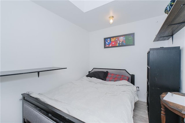 bedroom with wood finished floors and baseboards