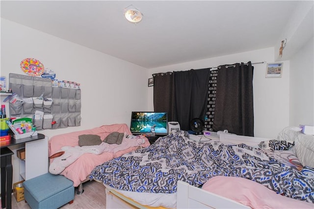 bedroom with wood finished floors