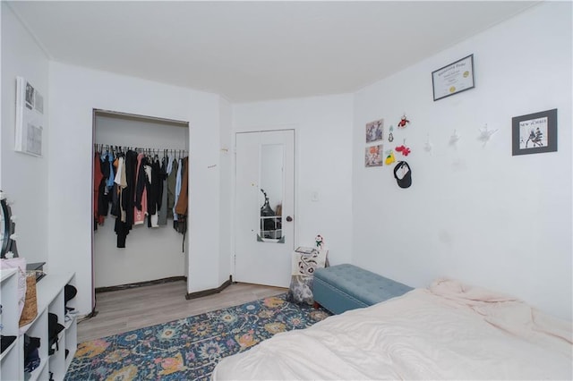 bedroom featuring wood finished floors and a closet